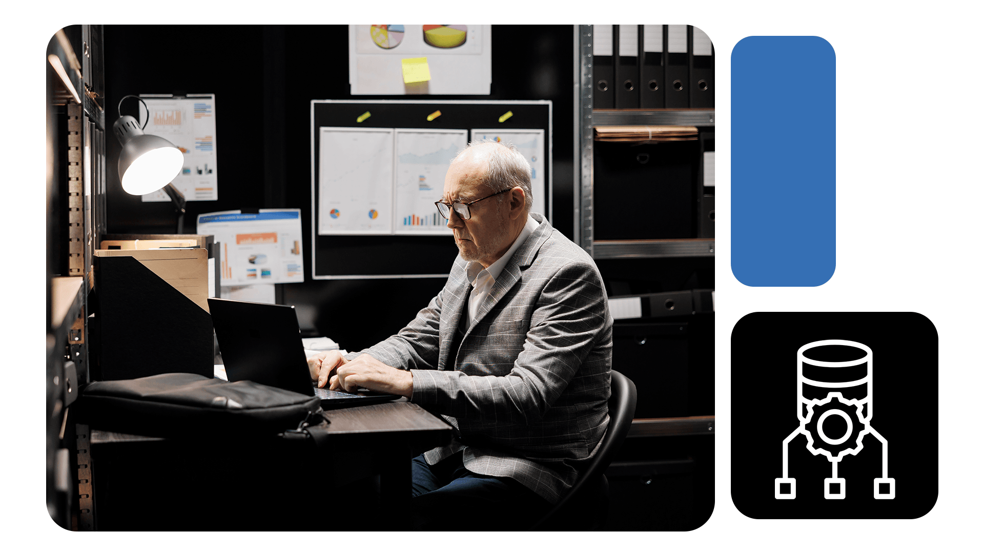 Homem maduro de terno trabalha em notebook em sala de arquivos com gráficos de dados na parede; ícone remete a banco de dados automatizado.